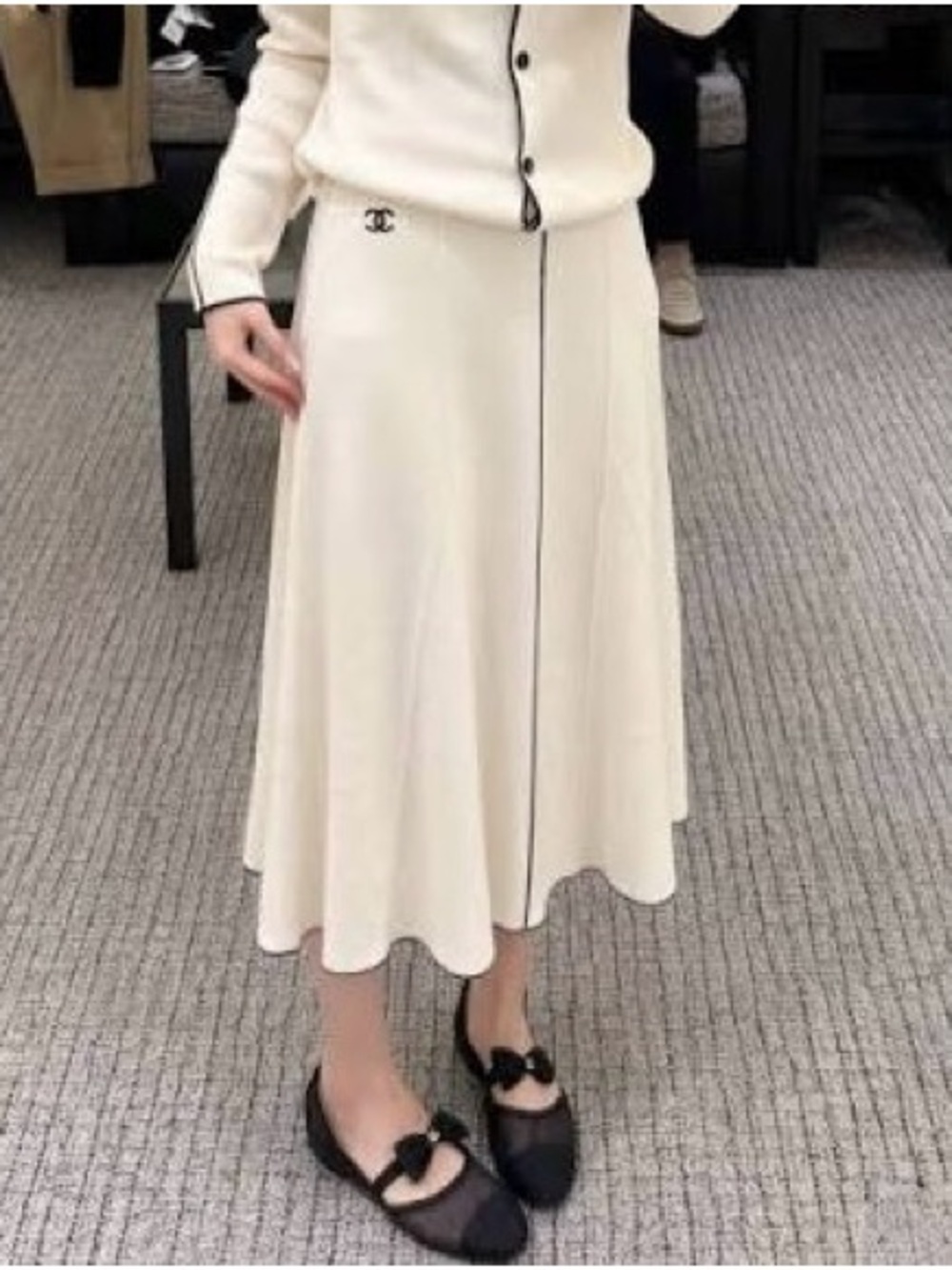 CHANEL Cream Midi Skirt with Black Trim and Logo Accent